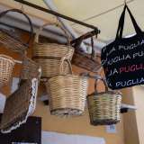 Anche qui spiccano le gerle appese al tendone, a cui fanno compagnia borse nere che riportano la dicitura �Puglia�...